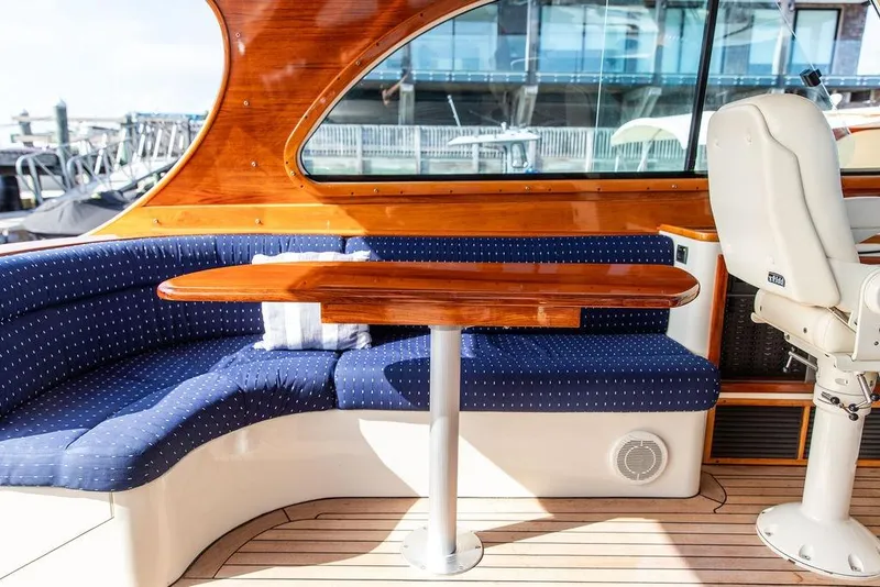 Slide: The Image of Interior of 2005 Hinckley Talaria 40 yacht with blue seating and wooden table. - 10