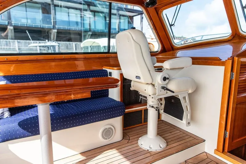 Slide: The Image of Interior of 2005 Hinckley Talaria 40 yacht with wooden finishes and cushioned seating. - 11