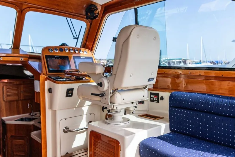 Slide: The Image of Interior of 2005 Hinckley Talaria 40 yacht with helm and seating area. - 19
