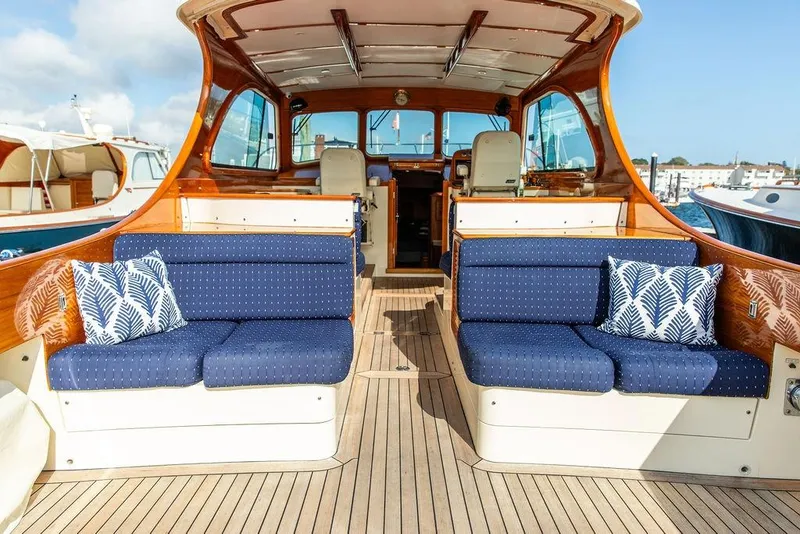 Slide: The Image of Luxurious 2005 Hinckley Talaria 40 yacht interior with blue seating and nautical decor. - 22