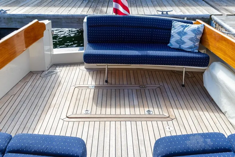 Slide: The Image of Luxurious 2005 Hinckley Talaria 40 yacht deck with elegant seating and wooden flooring. - 23