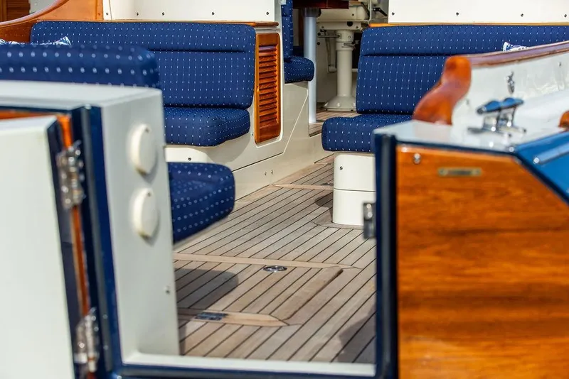 Slide: The Image of Interior of 2005 Hinckley Talaria 40 yacht with blue seating and wooden accents. - 25