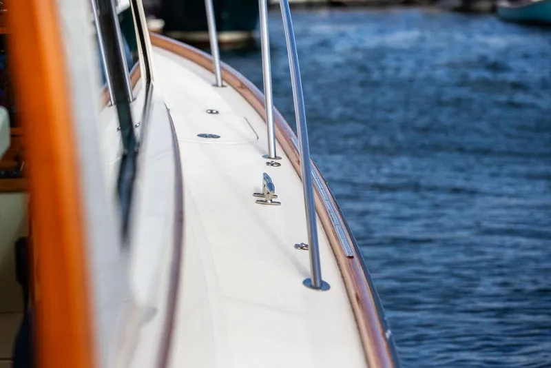 Slide: The Image of 2005 Hinckley Talaria 40 yacht deck with polished railings by the water. - 26