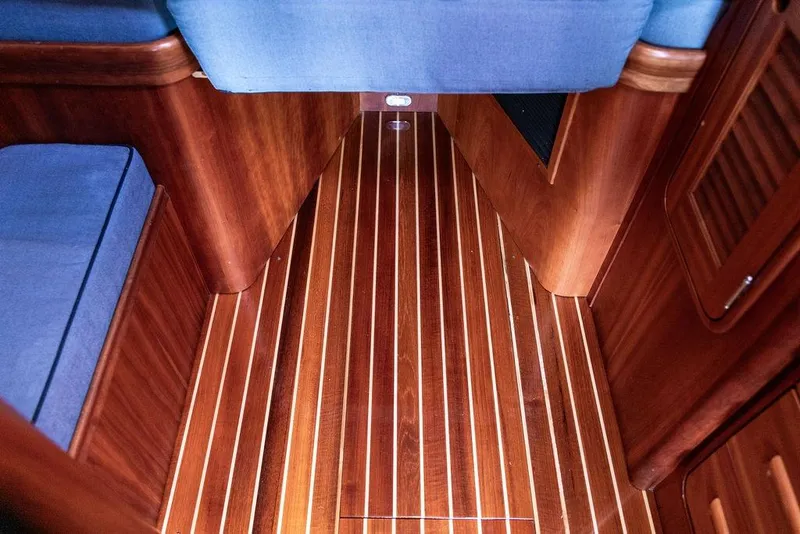 Slide: The Image of Interior of 2005 Hinckley Talaria 40 yacht with polished wooden flooring and blue seating. - 27