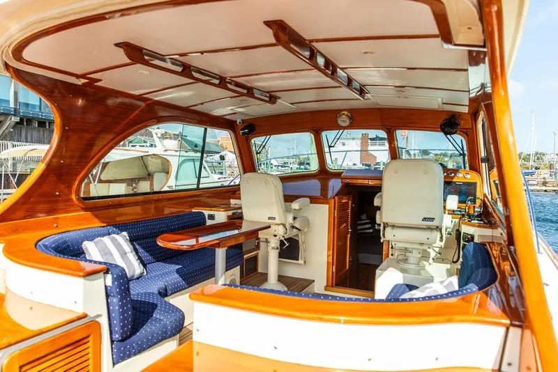 Slide: The Image of Interior of a 2005 Hinckley Talaria 40 yacht with elegant wood finish and seating. - 9