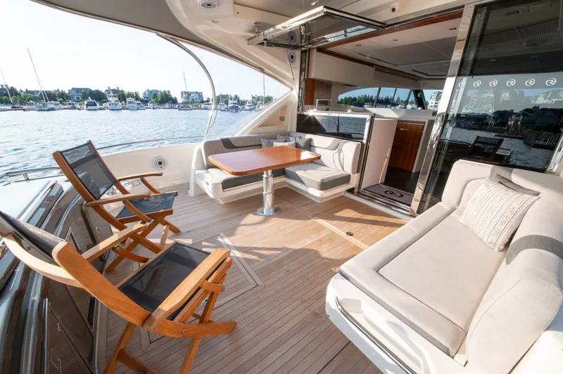 Slide: The Image of Luxurious 2022 Riviera 6000 Sport Yacht Platinum interior with elegant seating and waterfront view. - 16