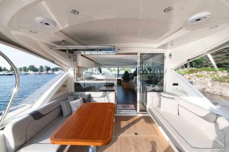 Slide: The Image of Luxurious interior of 2022 Riviera 6000 Sport Yacht Platinum with elegant seating and wooden table. - 20