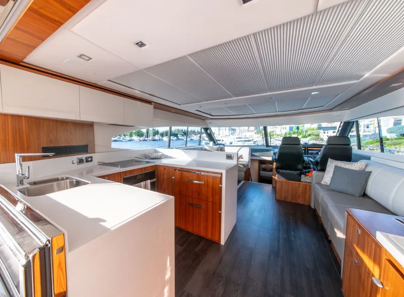 Slide: The Image of Luxurious interior of 2022 Riviera 6000 Sport Yacht Platinum with modern kitchen and seating. - 21