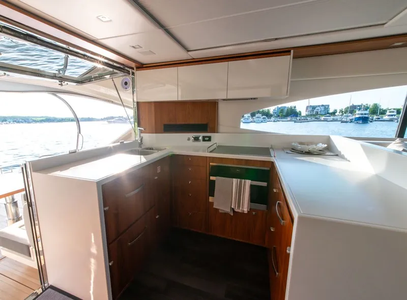 Slide: The Image of Luxurious interior of 2022 Riviera 6000 Sport Yacht Platinum with modern kitchen design. - 22