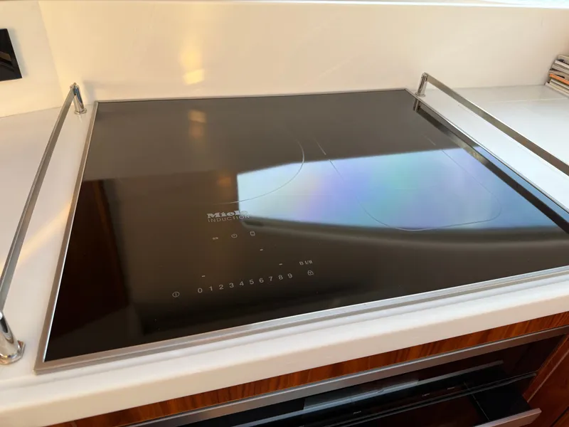 Slide: The Image of Miele induction cooktop on 2022 Riviera 6000 Sport Yacht Platinum kitchen. - 25