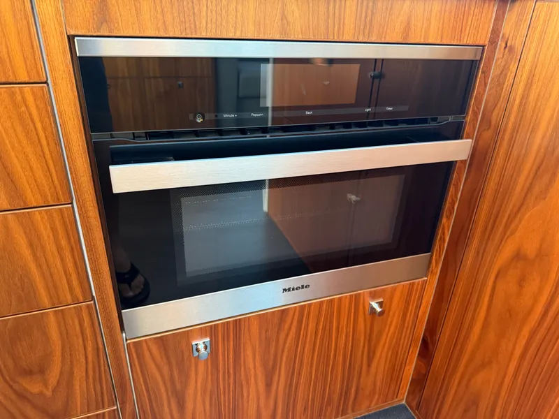 Slide: The Image of Built-in Miele microwave in 2022 Riviera 6000 Sport Yacht Platinum kitchen. - 26