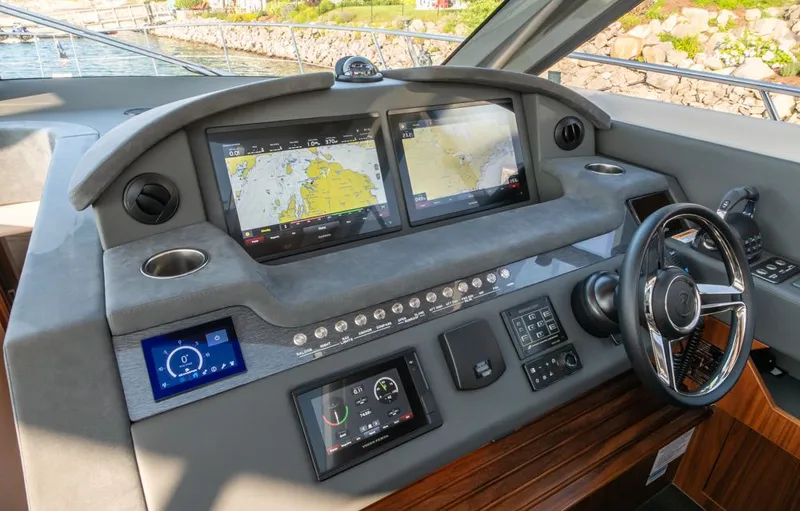 Slide: The Image of 2022 Riviera 6000 Sport Yacht Platinum helm with advanced navigation displays and controls. - 32