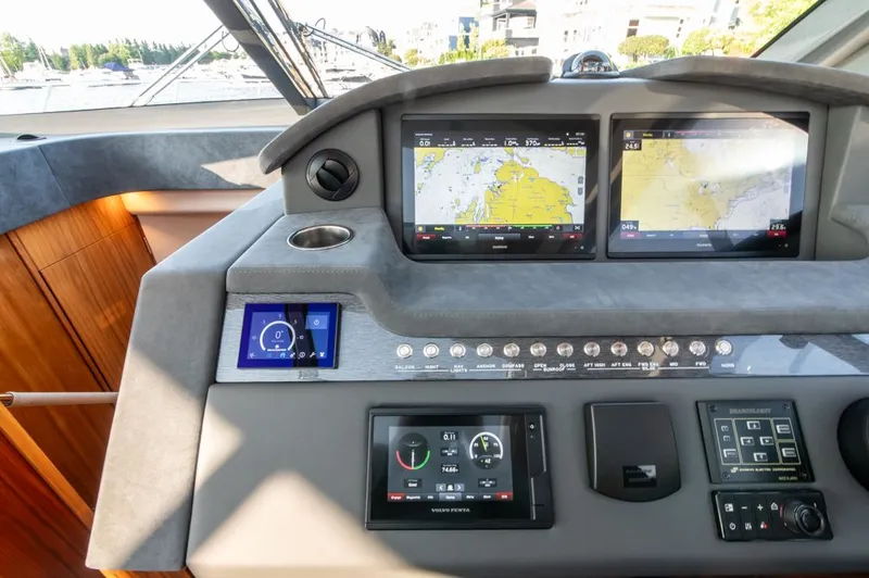 Slide: The Image of 2022 Riviera 6000 Sport Yacht Platinum dashboard with navigation screens and controls. - 33