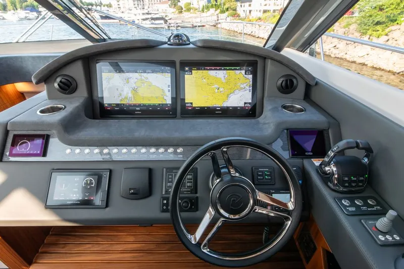 Slide: The Image of Helm of 2022 Riviera 6000 Sport Yacht Platinum with advanced navigation displays. - 34