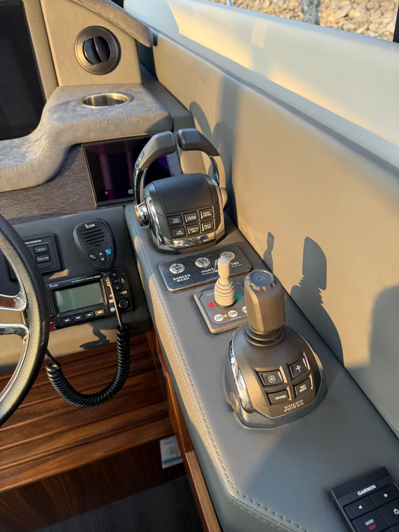 Slide: The Image of Control panel of 2022 Riviera 6000 Sport Yacht Platinum with joystick and throttle controls. - 36