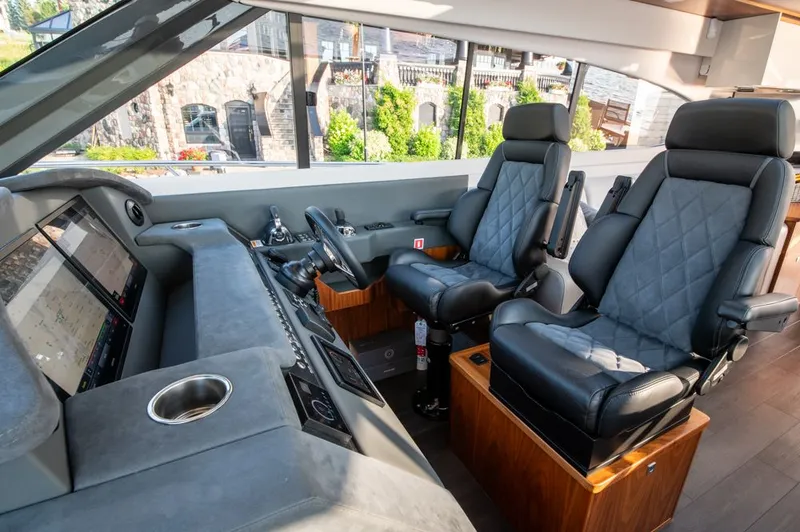 Slide: The Image of Interior of 2022 Riviera 6000 Sport Yacht Platinum with luxurious seating and modern controls. - 39