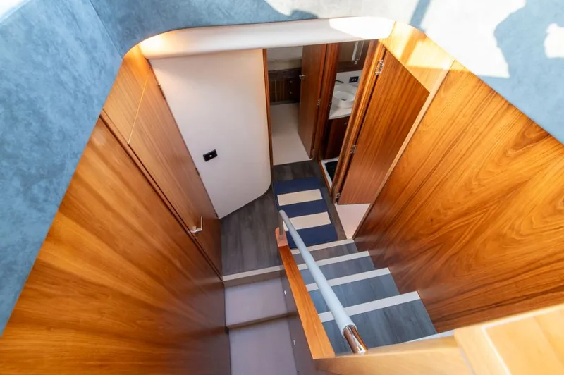 Slide: The Image of Interior view of 2022 Riviera 6000 Sport Yacht Platinum, featuring wooden stairs and modern design. - 41