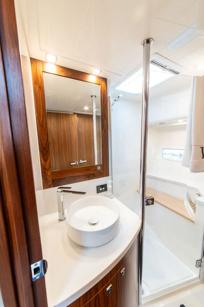 Slide: The Image of Luxurious bathroom in 2022 Riviera 6000 Sport Yacht Platinum, featuring modern fixtures and elegant wood accents. - 43