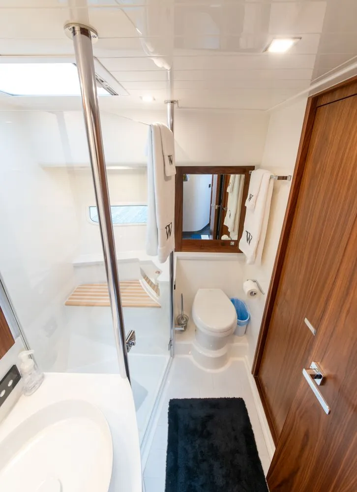 Slide: The Image of Luxurious bathroom in 2022 Riviera 6000 Sport Yacht Platinum, featuring modern fixtures and elegant wood accents. - 44
