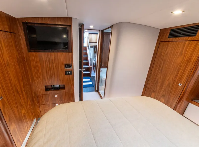 Slide: The Image of Interior of 2022 Riviera 6000 Sport Yacht Platinum with wood paneling and modern amenities. - 46