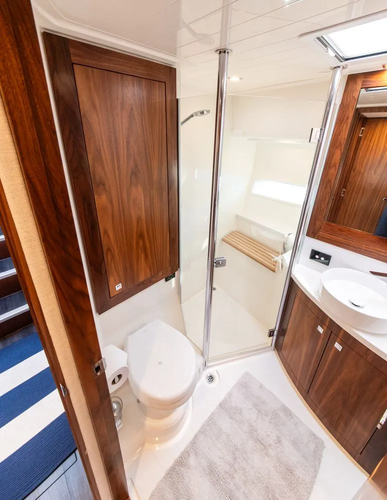 Slide: The Image of Luxurious bathroom in 2022 Riviera 6000 Sport Yacht Platinum, featuring wood accents and modern fixtures. - 47