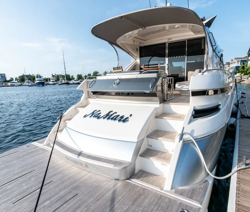 Slide: The Image of 2022 Riviera 6000 Sport Yacht Platinum docked at marina, rear view. - 7