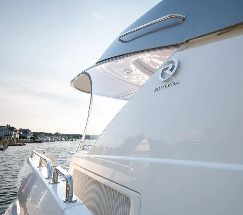 Slide: The Image of 2022 Riviera 6000 Sport Yacht Platinum docked, showcasing sleek design and luxury features. - 9