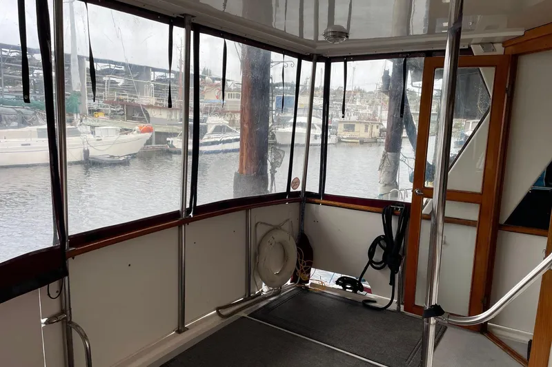 Slide: The Image of 1986 NOVA MARINE 36 Sundeck interior with marina view through large windows. - 11