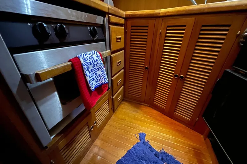 Slide: The Image of Galley kitchen in 1986 NOVA MARINE 36 Sundeck with wooden cabinets and stove. - 3