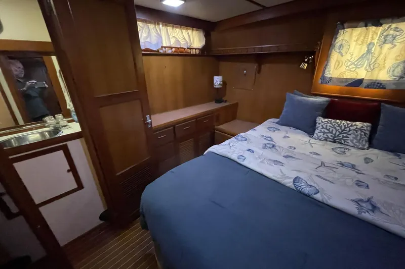 Slide: The Image of Cozy interior of 1986 NOVA MARINE 36 Sundeck with bed, wooden cabinetry, and nautical decor. - 6