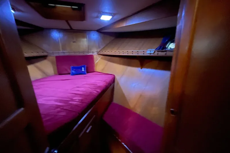 Slide: The Image of Cozy cabin interior of 1986 NOVA MARINE 36 Sundeck with red bedding and wooden walls. - 8