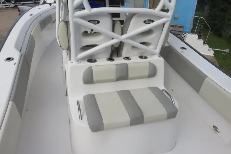 Slide: The Image of 2020 Cape Horn 31 T boat with center console and seating, surrounded by greenery. - 25