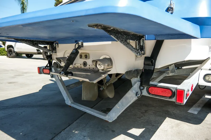 Slide: The Image of Rear view of 2007 MasterCraft X-2 SS boat on trailer, showing propeller and trim tabs. - 16