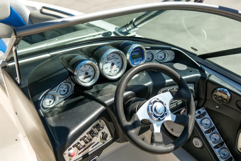 Slide: The Image of 2007 MasterCraft X-2 SS boat dashboard with gauges and steering wheel. - 20