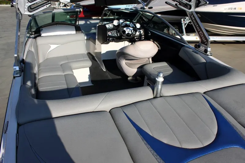 Slide: The Image of 2007 MasterCraft X-2 SS boat interior with gray seating and modern dashboard. - 4