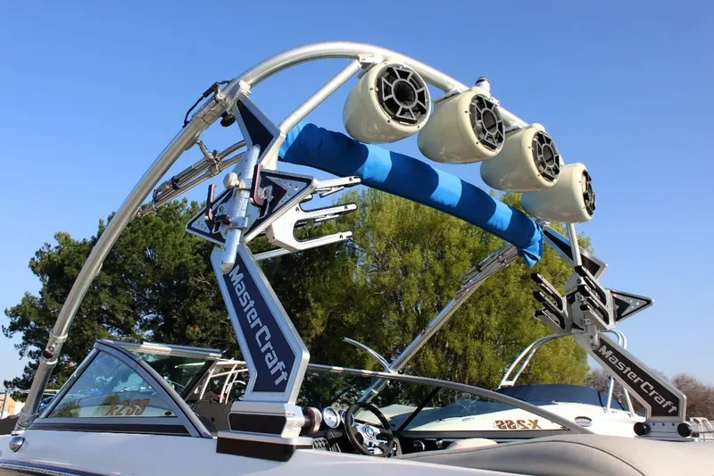 Slide: The Image of 2007 MasterCraft X-2 SS boat with wakeboard tower and speakers, parked outdoors. - 5
