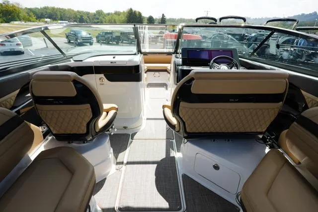 Slide: The Image of 2024 Sea Ray 280 SLX boat interior with luxurious seating and modern dashboard. - 11
