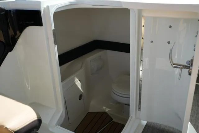 Slide: The Image of 2024 Sea Ray 280 SLX boat interior with compact bathroom and modern amenities. - 12