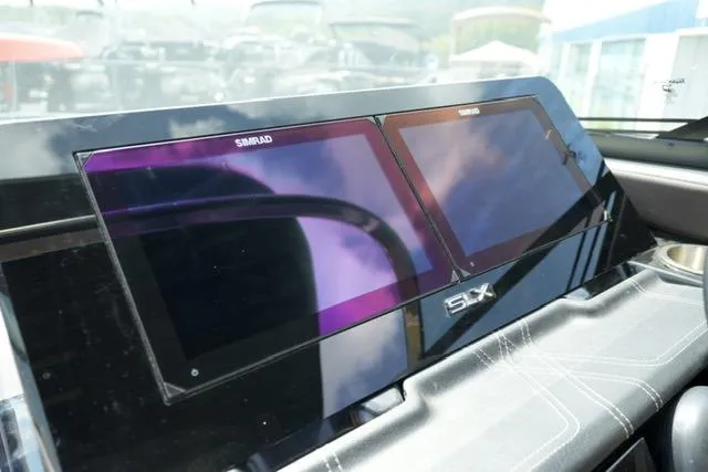 Slide: The Image of 2024 Sea Ray 280 SLX dashboard with dual Simrad displays, sleek and modern design. - 16