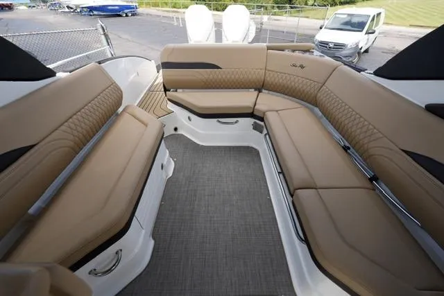 Slide: The Image of 2024 Sea Ray 280 SLX boat interior with tan leather seating and modern design. - 17