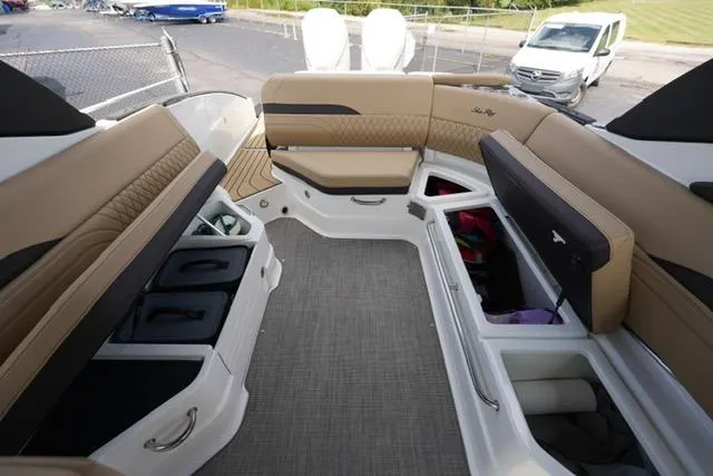 Slide: The Image of 2024 Sea Ray 280 SLX boat interior with tan seating and ample storage compartments. - 18