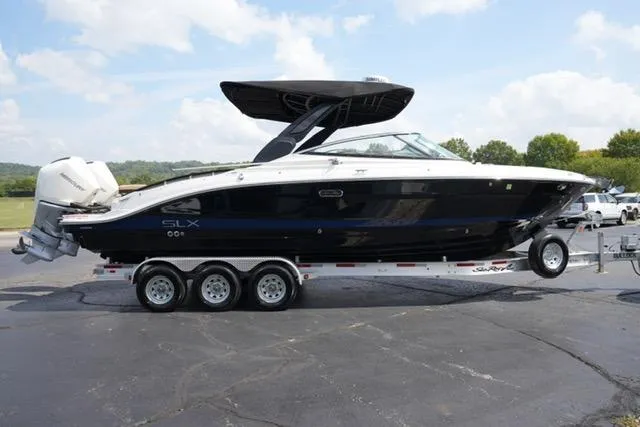 Slide: The Image of 2024 Sea Ray 280 SLX boat on a trailer, parked outdoors under a clear sky. - 3