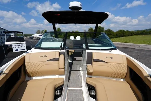 Slide: The Image of 2024 Sea Ray 280 SLX boat interior with tan seating and sleek design. - 9