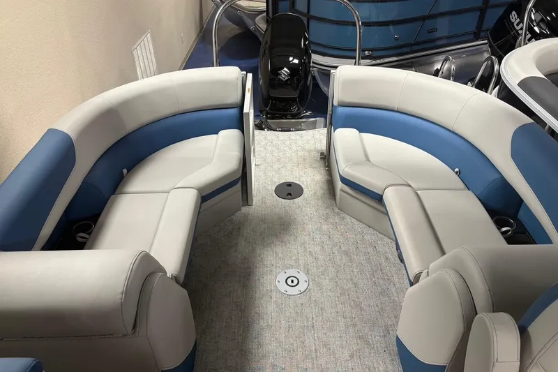 Slide: The Image of 2025 South Bay 222 LE pontoon boat interior with blue and gray seating. - 4