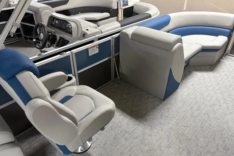 Slide: The Image of 2025 South Bay 222 LE pontoon boat interior with plush seating and modern dashboard. - 8