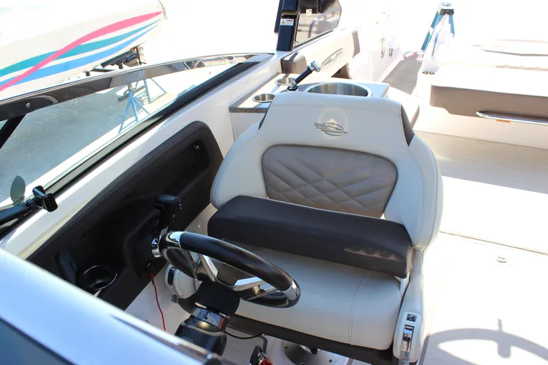 Slide: The Image of 2018 Chaparral 287 SSX boat interior with steering wheel and captain's seat. - 17