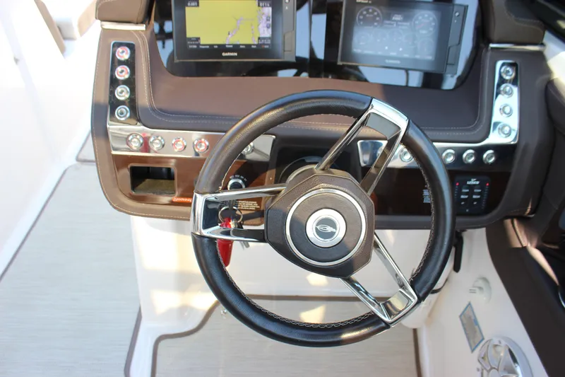 Slide: The Image of 2018 Chaparral 287 SSX boat dashboard with steering wheel and navigation displays. - 20