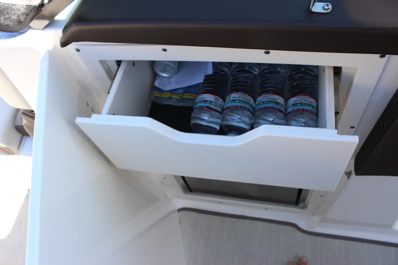 Slide: The Image of Open storage drawer with water bottles on 2018 Chaparral 287 SSX boat. - 32
