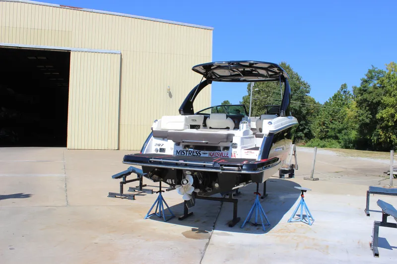 Slide: The Image of 2018 Chaparral 287 SSX boat on stands outside a large storage building. - 41