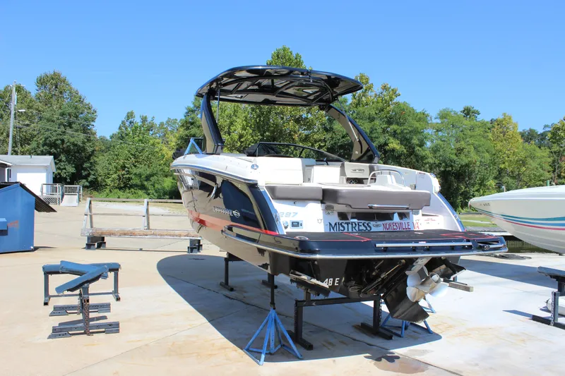 Slide: The Image of 2018 Chaparral 287 SSX boat on stands, outdoor setting, clear sky. - 43